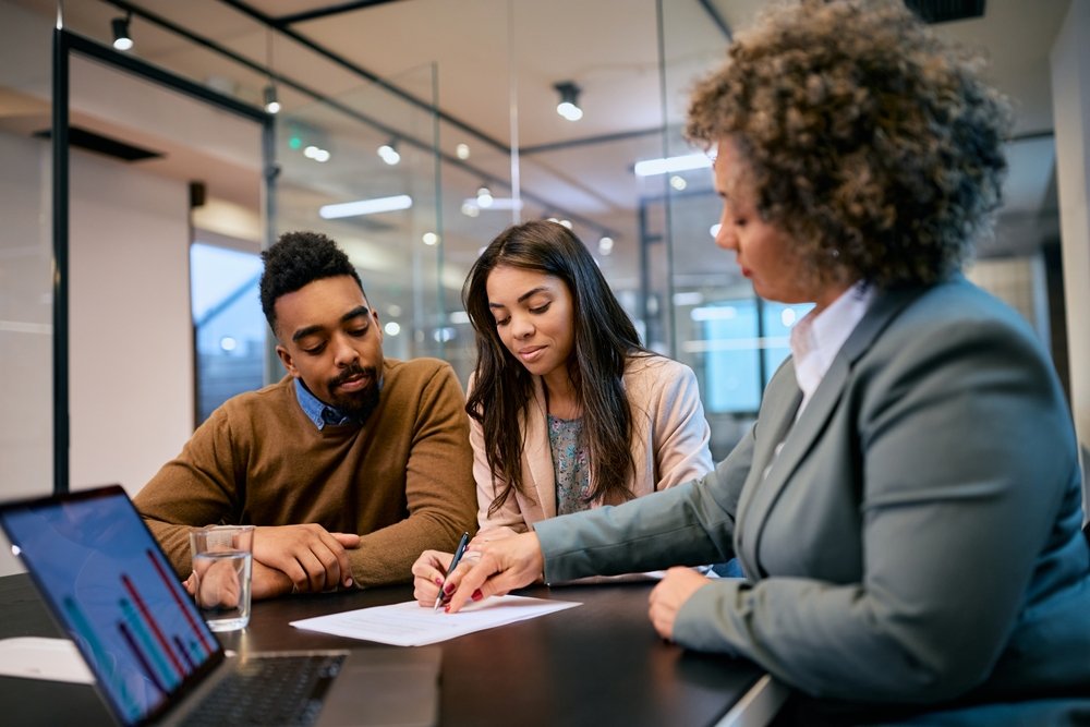 African,American,Woman,And,Her,Husband,Signing,Mortgage,Agreement,During